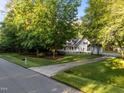 Beautiful home with a long driveway, mature trees, and a charming exterior at 2616 Dockery Ln, Raleigh, NC 27606
