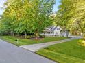 Charming home with a well-manicured front yard and long driveway surrounded by mature trees offering curb appeal at 2616 Dockery Ln, Raleigh, NC 27606