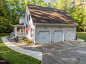 Spacious three-car garage attached to a charming home with well-manicured landscaping at 2616 Dockery Ln, Raleigh, NC 27606