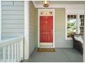 Charming front porch with a red door featuring the house number and a 'welcome' mat at 2720 Snowy Meadow Ct, Raleigh, NC 27614