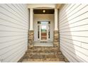 Inviting front entrance with stone pillars and natural stone walkway at 2910 Reynolda Cir, Durham, NC 27712