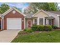 Charming brick and siding home with a well-manicured front lawn and attached garage at 3027 Maple Ave # M2, Burlington, NC 27215