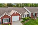 Aerial view of a charming brick and siding home with well-manicured landscaping and driveway at 3027 Maple Ave # M2, Burlington, NC 27215