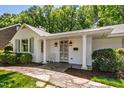 Inviting front porch with stone pathway, columns, and classic exterior lighting at 3028 Rothgeb Dr, Raleigh, NC 27609