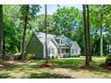 Scenic view of a home nestled among trees, showcasing its curb appeal and harmonious blend with nature at 305 Monterey Ct, Benson, NC 27504