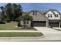 Attractive two-story home with brick facade, lush lawn, and a convenient two-car garage at 3406 Antler View Dr, Apex, NC 27502