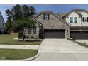 Beautiful brick home with meticulously kept lawn, a tree-lined yard, and convenient attached two-car garage at 3406 Antler View Dr, Apex, NC 27502