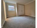 This spacious bedroom features neutral carpet, one window, and a closet with double doors at 3523 Ivy Commons Dr # 102, Raleigh, NC 27606