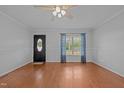 Bright living room featuring beautiful hardwood floors, a ceiling fan, and plenty of natural light at 3603 Westmeadow Ln, Elon, NC 27244
