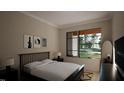 Inviting bedroom with neutral tones, a plush bed, and a large window offering natural light at 389 Deer Tail Ln # 39, Fuquay Varina, NC 27526