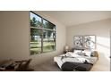Bright bedroom with large window overlooking green landscape, modern decor, and a comfortable bed at 389 Deer Tail Ln # 39, Fuquay Varina, NC 27526