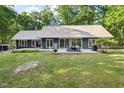 Spacious backyard with a concrete patio featuring an outdoor dining set and grill at 4022 Tecolote Way, Hillsborough, NC 27278