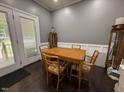 Cozy dining area with a wooden table set for four, complemented by natural light and built-in display cabinet at 4057 Old Franklinton Rd, Franklinton, NC 27525