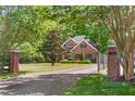 Charming brick home with a long private driveway and landscaped front yard at 412 Bowen Rd, Rougemont, NC 27572