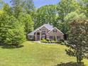 Beautiful two-story brick home surrounded by lush green trees at 412 Bowen Rd, Rougemont, NC 27572