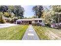 Inviting single-story home with a well-manicured lawn and charming front walkway at 4501 Rockwood Dr, Raleigh, NC 27612
