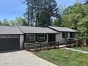 Beautiful home featuring a spacious deck, and a well-maintained lawn at 4501 Rockwood Dr, Raleigh, NC 27612
