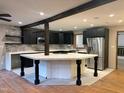 Modern kitchen with stainless steel appliances, dark cabinets, and a large island at 4501 Rockwood Dr, Raleigh, NC 27612