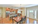 Well-appointed kitchen with a center island, modern stainless steel appliances, and a dining area with natural light at 457 S Greensboro St, Carrboro, NC 27510