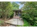 Charming front entrance featuring stone accents, a stylish blue door, and lush landscaping at 4832 Brookhaven Dr, Raleigh, NC 27612