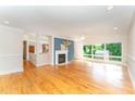 Spacious living room features hardwood floors, fireplace, blue accent wall, and large windows at 4832 Brookhaven Dr, Raleigh, NC 27612