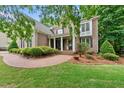 Charming brick home featuring a manicured front yard, garden, and a welcoming brick walkway at 5217 Roswellcrest Ct, Apex, NC 27539