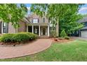 Attractive brick home featuring manicured landscaping, a circular brick walkway, and a welcoming front entrance at 5217 Roswellcrest Ct, Apex, NC 27539