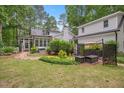 Spacious backyard with mature landscaping, a hot tub, and an outdoor seating area at 5241 Mill Dam Rd, Wake Forest, NC 27587