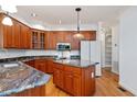 Gourmet kitchen with cherry cabinets, granite countertops, and stainless appliances at 5241 Mill Dam Rd, Wake Forest, NC 27587