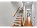 A well-lit staircase with wooden rails and white risers leads to the upper floor at 5310 Echo Ridge Rd, Raleigh, NC 27612