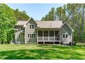 This backyard features a screened in porch and large fire pit at 59 Mill Rd, Pittsboro, NC 27312