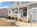 Inviting front porch features tasteful decor and charming details, enhancing the home's curb appeal at 59 Nevada Ct, Clayton, NC 27527