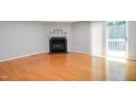 Bright living room with hardwood floors and a cozy fireplace at 603 Middleton Ave, Cary, NC 27513