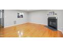 Inviting living room featuring hardwood floors and a modern fireplace at 603 Middleton Ave, Cary, NC 27513