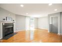 Spacious living room with hardwood floors, fireplace, and sliding door to deck at 603 Middleton Ave, Cary, NC 27513