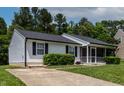 Well-maintained home with a driveway, showcasing a classic design and inviting atmosphere at 605 Larchwood Dr, Durham, NC 27713