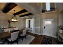 Bright dining area featuring dark wood floors, a modern light fixture, and views of a sunny window at 6104 Hope Farm Ln # 18, Wake Forest, NC 27587