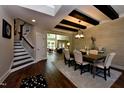 Elegant dining room with beamed ceilings, wood floors, stylish furniture, and abundant natural light at 6104 Hope Farm Ln # 18, Wake Forest, NC 27587