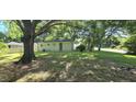 Expansive backyard with lush green grass and mature trees, perfect for outdoor activities at 626 Hoover Rd, Durham, NC 27703