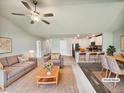 Spacious living room open to kitchen, with ceiling fan, stylish decor, and ample natural light at 631 Southwick Pl, Mebane, NC 27302