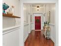 Elegant hallway with hardwood floors, wainscoting, and stylish decor at 7227 Cleveland Rd Rd, Clayton, NC 27520