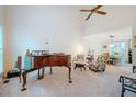Spacious living room with high ceilings and a piano, leading into the dining area at 8 Wexford Dr, Durham, NC 27713