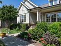 Close-up of a beautifully landscaped home with flower beds and blooming shrubbery at 8461 Lentic Ct, Raleigh, NC 27615