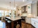 Beautiful kitchen with a large island, pendant lighting, and stainless steel appliances at 8461 Lentic Ct, Raleigh, NC 27615