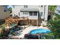 Backyard oasis with a pool, multi-level deck, and patio seating area, ideal for outdoor entertaining at 8724 Deerland Grove Dr, Raleigh, NC 27615