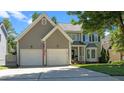 Charming home with a two-car garage, manicured lawn, and classic exterior, perfect for Gathering living at 8724 Deerland Grove Dr, Raleigh, NC 27615
