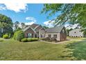 Charming single-story home featuring brick accents, lush landscaping, and a well-manicured lawn at 95 Live Oak Dr, Louisburg, NC 27549