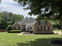 Beautiful single Gathering home featuring brick and siding, manicured lawn, and well-maintained landscaping at 95 Live Oak Dr, Louisburg, NC 27549