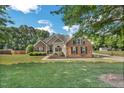 Charming brick and siding home with a well-maintained lawn and mature trees at 95 Live Oak Dr, Louisburg, NC 27549