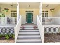 Charming front porch with hanging flower baskets, rocking chairs, and steps leading to the entrance at 101 Rainbow Dr, Carrboro, NC 27510